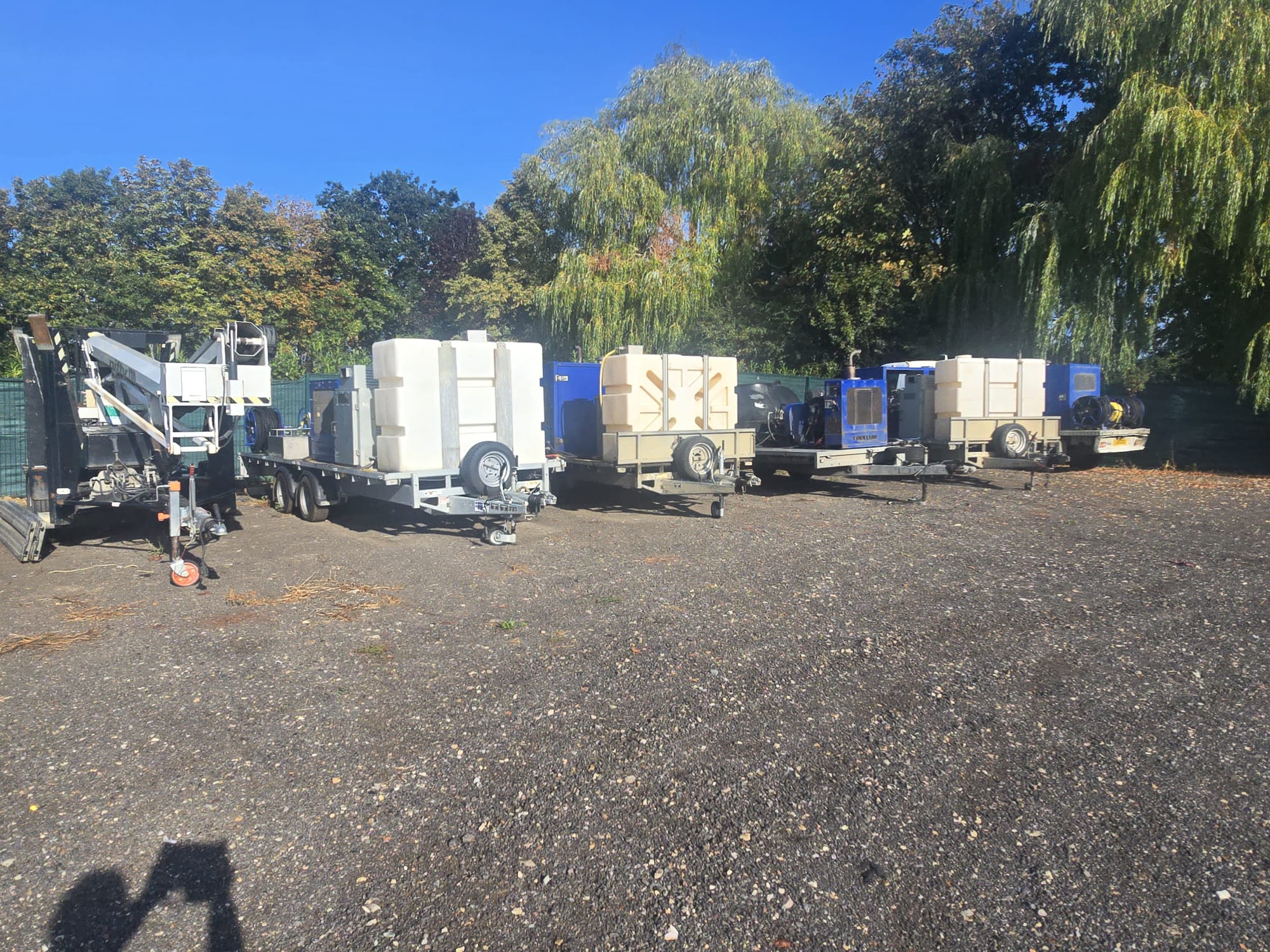 Line-up of wash trailers, water tanks, pumps and access platforms in the yard